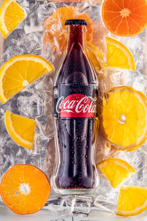 A bottle of Coca-Cola no sugar and slices of orange and citrus on the background of ice cubes. Russia, Krasnoyarsk, March 17, 2021のeditorial素材