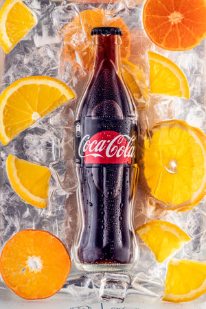 A bottle of Coca-Cola no sugar and slices of orange and citrus on the background of ice cubes. Russia, Krasnoyarsk, March 17, 2021のeditorial素材