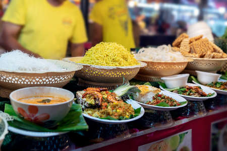 thai food at the market in Phuket. noodles, tom yam soup, salads and traditional street food of Thailand on displayの写真素材