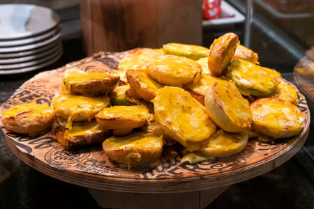 small baguette sandwiches with baked melted cheese on top, on the distribution in the bakery buffet, snackの写真素材