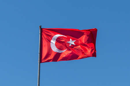 Turkish flag on the background of a clear empty skyの写真素材
