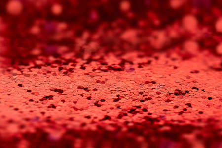 red background of bright shiny confetti in out of focus. empty copyspace layout for valentines day template or valentines day productsの写真素材