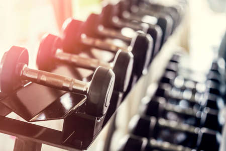 sports dumbbells in the fitness room close-up. Training is the concept of a healthy lifestyle.の写真素材