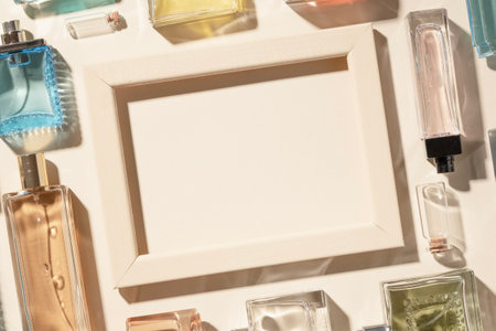 Perfumes and cosmetics, beige frame and blank background of copyspace for ads and advertisements. The beauty and fashion industry, transparent various bottles of cologne and perfume.の写真素材