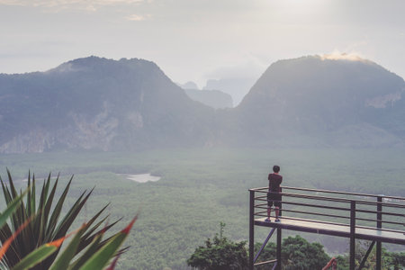 A photographer photographs a beautiful view from the Samet Nanghse observation deck in Thailand. Magnificent mountain landscape for lovers of landscape photography, tourists and travelersの写真素材