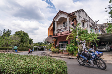 Thailand, Phang Nga March 2, 2023. Streets of the old town of Takua Pa, Phang Nga Province, Cozy two-story house and passing motorcyclist. Life of Takua Paのeditorial素材