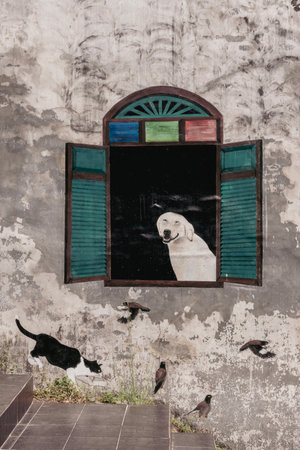 Thailand, Phang Nga March 2, 2023. Street art on the walls of the old center of Takua Pa. The dog...