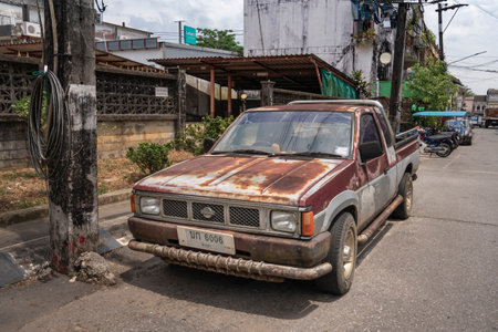 An old and rusty Nissan pickup truck on the street of the old town of Takua Pa in Thailand Takua Pa Thailand, Phang Nga March 2, 2023.のeditorial素材