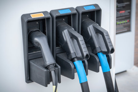 Charging electric vehicles. three Plugs for charging electric cars close-up, concept.の写真素材