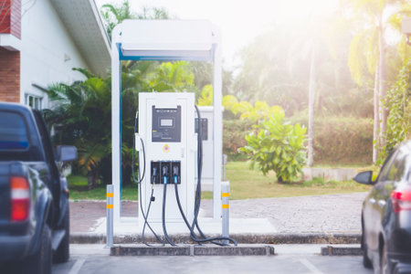 Car charging station in front of a green flowering backgroundの写真素材