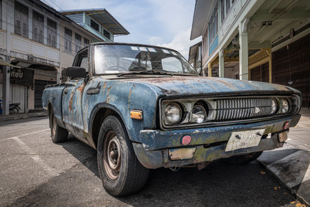 An old, battered and rusty Japanese pickup truck DATSUN close-up on the street in Thailand, in the old town of Takua Pa, Takua Pa Thailand, Phang Nga March 2, 2023のeditorial素材