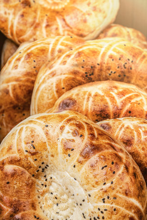 Uzbek Tajik Turkish traditional flatbreads, delicious oriental lavash bread Deliciously Freshly Baked Soft Bread Rolls with a Beautifully Golden and Crunchy Crust on Topの写真素材