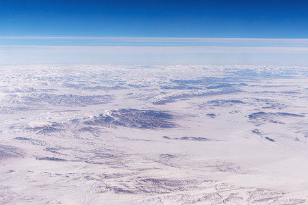 Tangla Mountain range in China, snow-capped mountain ranges like a moonscape under snow. Inner Mongolia View from an airplane window from a high altitude.の写真素材