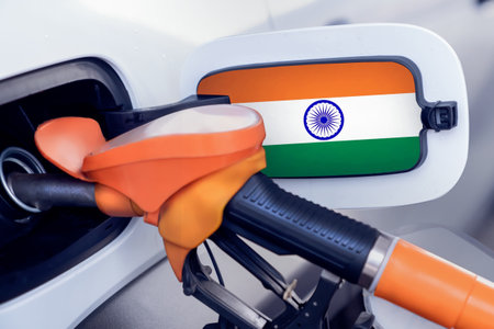 The flag of India on the lid of the gas tank of a car at a gas station in close-up. High or low...
