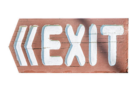 Wooden signpost featuring the word exit in bold white letters with arrows pointing to the left,...