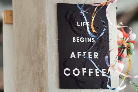 Life begins after coffee - A close-up of the slogan on a coffee shop sign - an element of the decoration of the coffee shop's interior. High quality photo.の写真素材