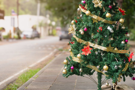 Christmas tree decorated with balloons and a yellow shiny ribbon with sequins on the street of Phuket during the day in Thailand, close-up, Christmas. New Years Eve in Southeast Asia. High qualityの写真素材