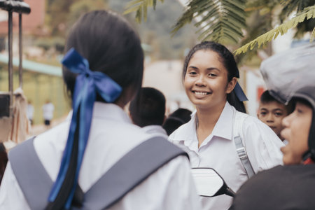 Khao Lak, Thailand, 24 11 2025: Thai school - the face of a teenage schoolgirl in close-up, students talking on the street in Thailand after school surrounded by classmates and enjoying spending timeのeditorial素材