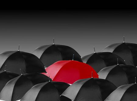 Image of multiple umbrella with one single red umbrellaの写真素材