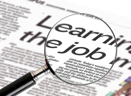 Image of magnifiying glass searching for job vacancyの写真素材