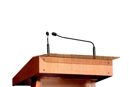 Seminar podium and microphones over whiteの写真素材