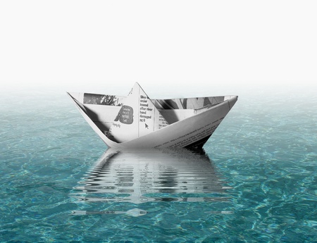 Paper boat on waterの写真素材