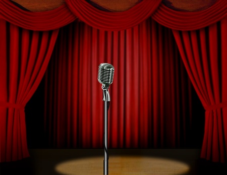 Retro microphone and red curtain on a stage with spotlightの写真素材