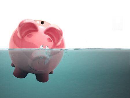 Drowning Piggy bank in waterの写真素材