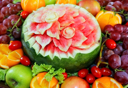 Watermelon fruit carved flower shape and fruitsの写真素材