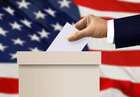 Ballot box with person hand casting a voteの写真素材