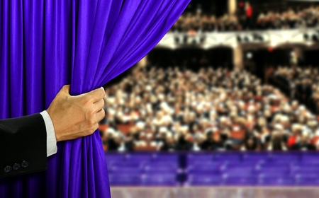 Hand opening stage curtain and audianceの写真素材