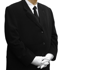man in black suit standing over whiteの写真素材