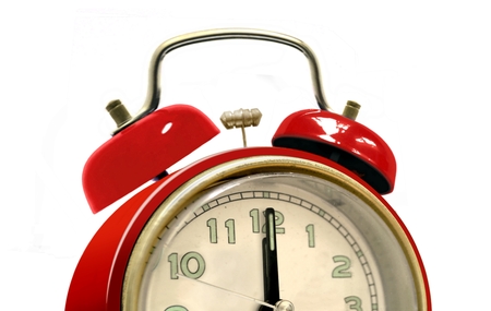Half red alarm clock over white