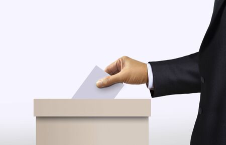 Ballot box with person in suit hand casting a voteの写真素材