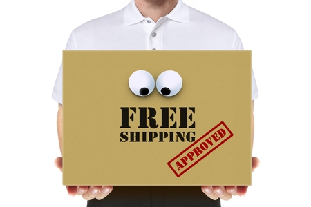 Delivery man carry a free shipping parcel over whiteの写真素材