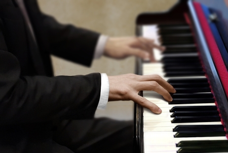 Man in black suit playing pianoの写真素材