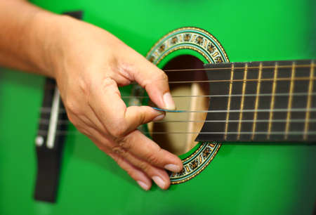Hand playing guitar close upの写真素材