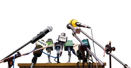 Press conference microphones on white backgroundの写真素材