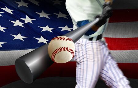 Baseball player hitting ball with American flag in backgroundの写真素材