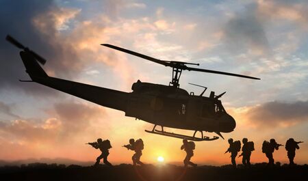 Military special force assault team helicopter drops during sunsetの写真素材