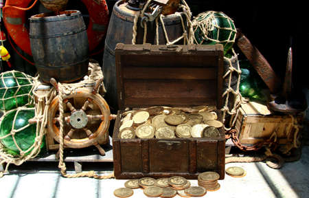Gold coins treasure chest inside a pirates shipの写真素材