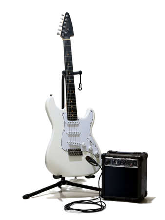 White electric guitar with small amplifier over white
