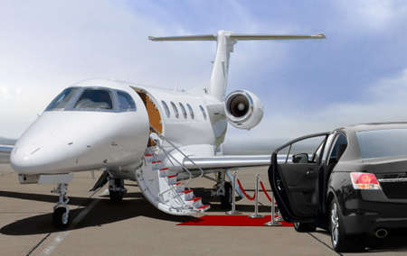 Private jet and black car waiting on landing strip in airportの写真素材