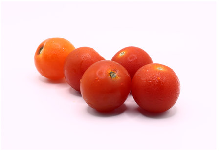 fresh red cherry tomatoes on white backgroundの写真素材
