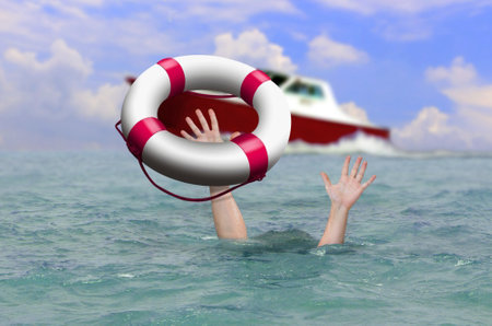Rescue boat using life buoy trying to save drowning person at sea.の写真素材