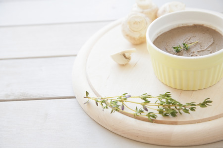 can of chicken liver pate on wooden desk with thyme and muchroomsの写真素材
