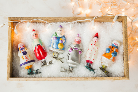 Vintage Soviet Christmas tree toys in wooden hutch on artificial snow. Retro New Year or Christmas postcard concept.の写真素材