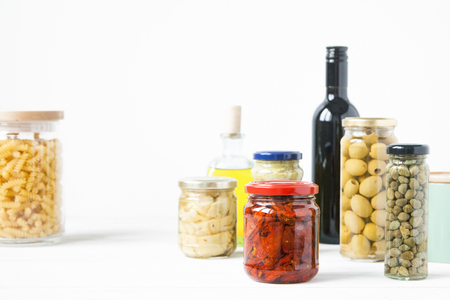 Variety of typical Italian food preserved in glass jars. Minimal.の写真素材