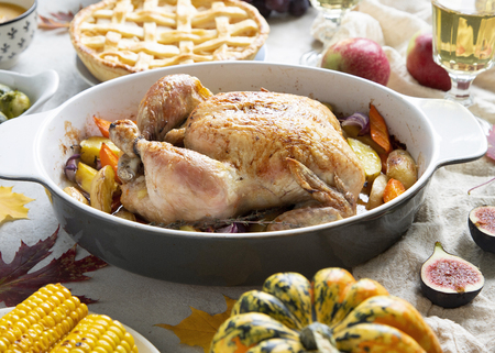 Thanksgiving dinner with chicken, apple pie, pumpkin soup brussel sprouts and fruits. Traditional autumn food concept.の写真素材