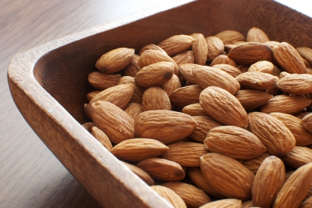 Almonds nuts in wooden bowl の写真素材